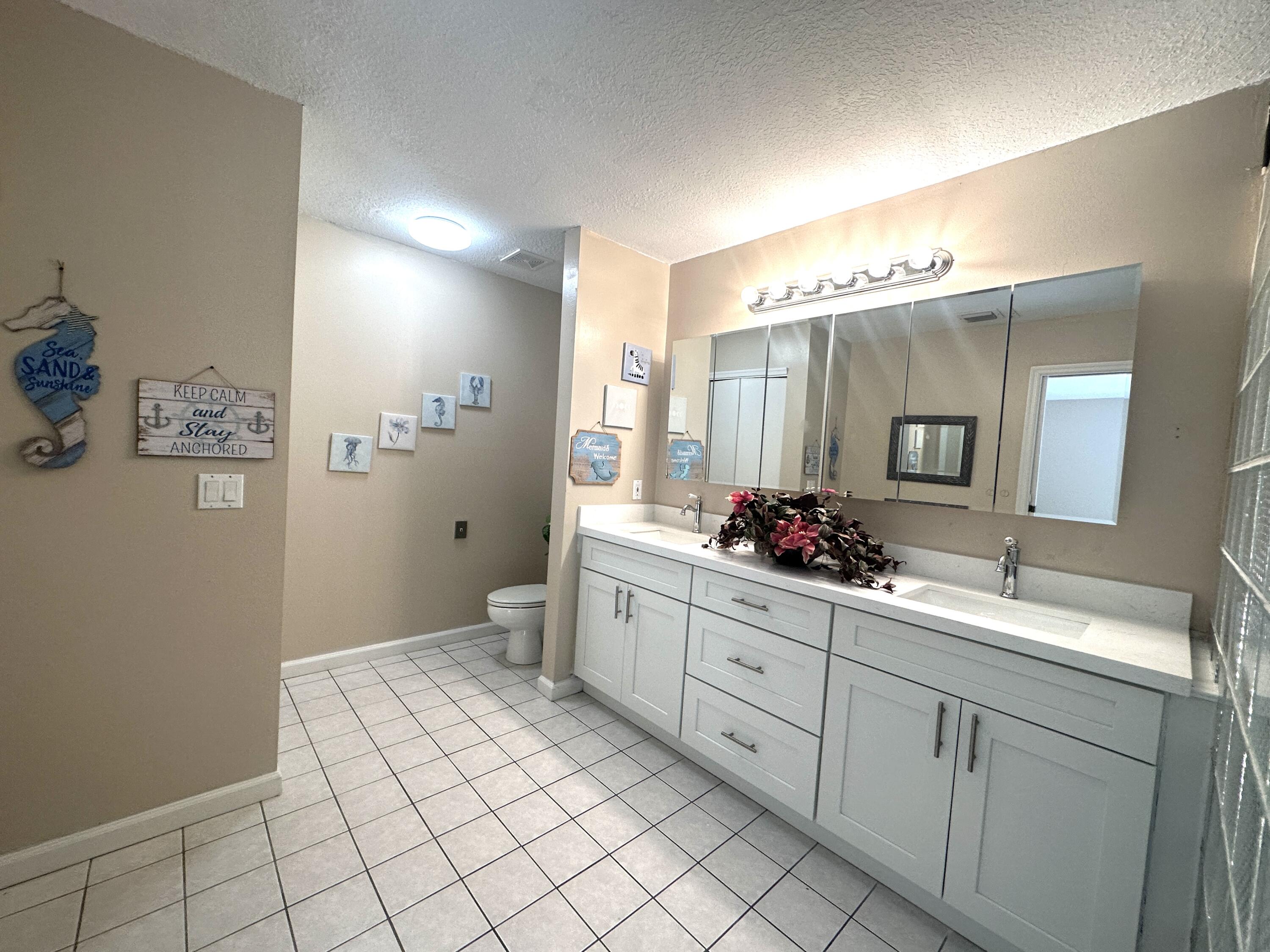 13338 76th Road North West Palm Beach, FL 33412 - Photo 83 of 138 a spacious bathroom with a double vanity sink mirror and toilet