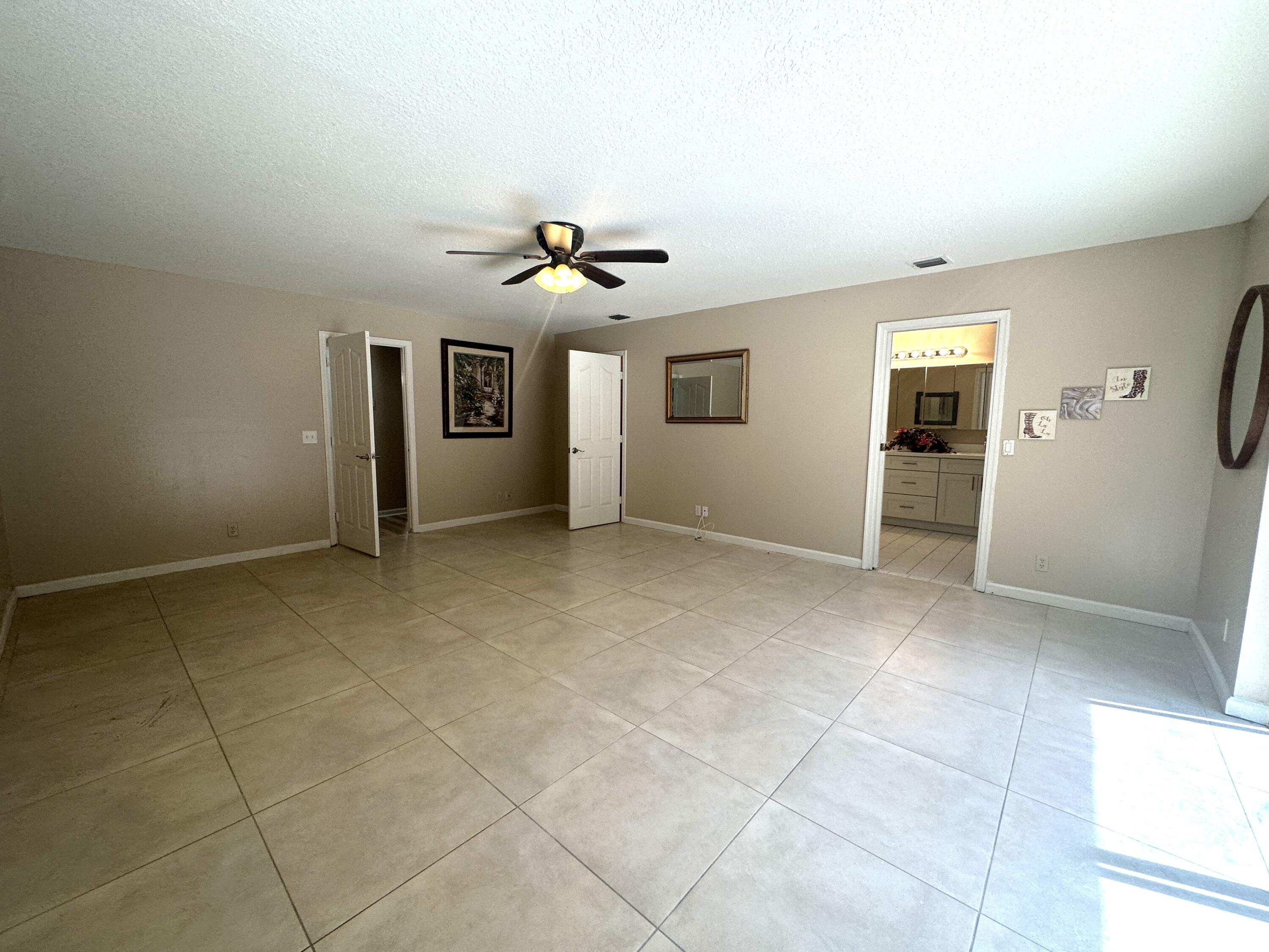 13338 76th Road North West Palm Beach, FL 33412 - Photo 85 of 138 a view of a livingroom with a stylish ceiling fan and window