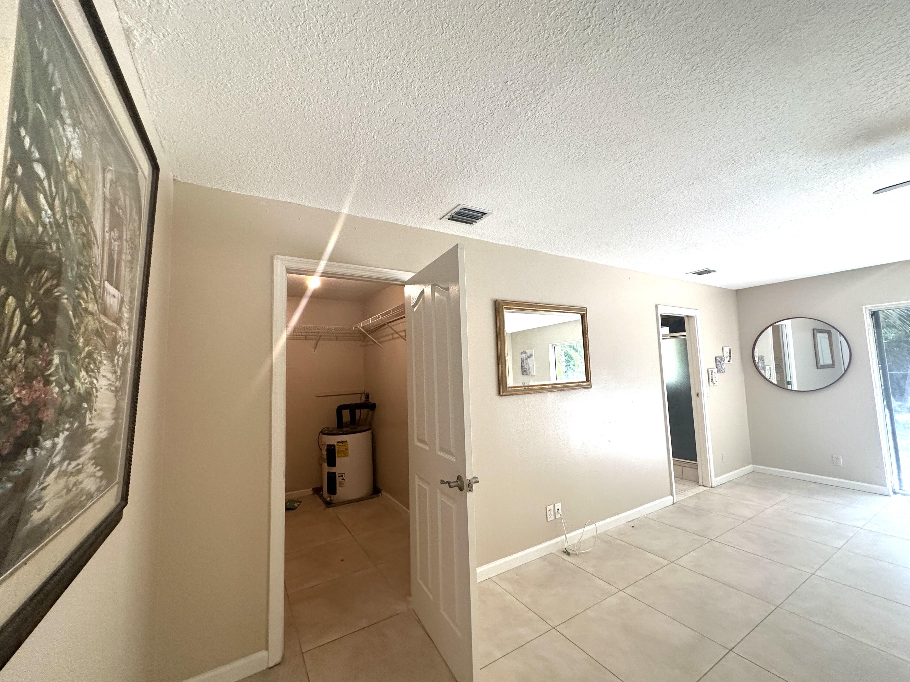 13338 76th Road North West Palm Beach, FL 33412 - Photo 87 of 138 a view of a hallway with closet and bathroom