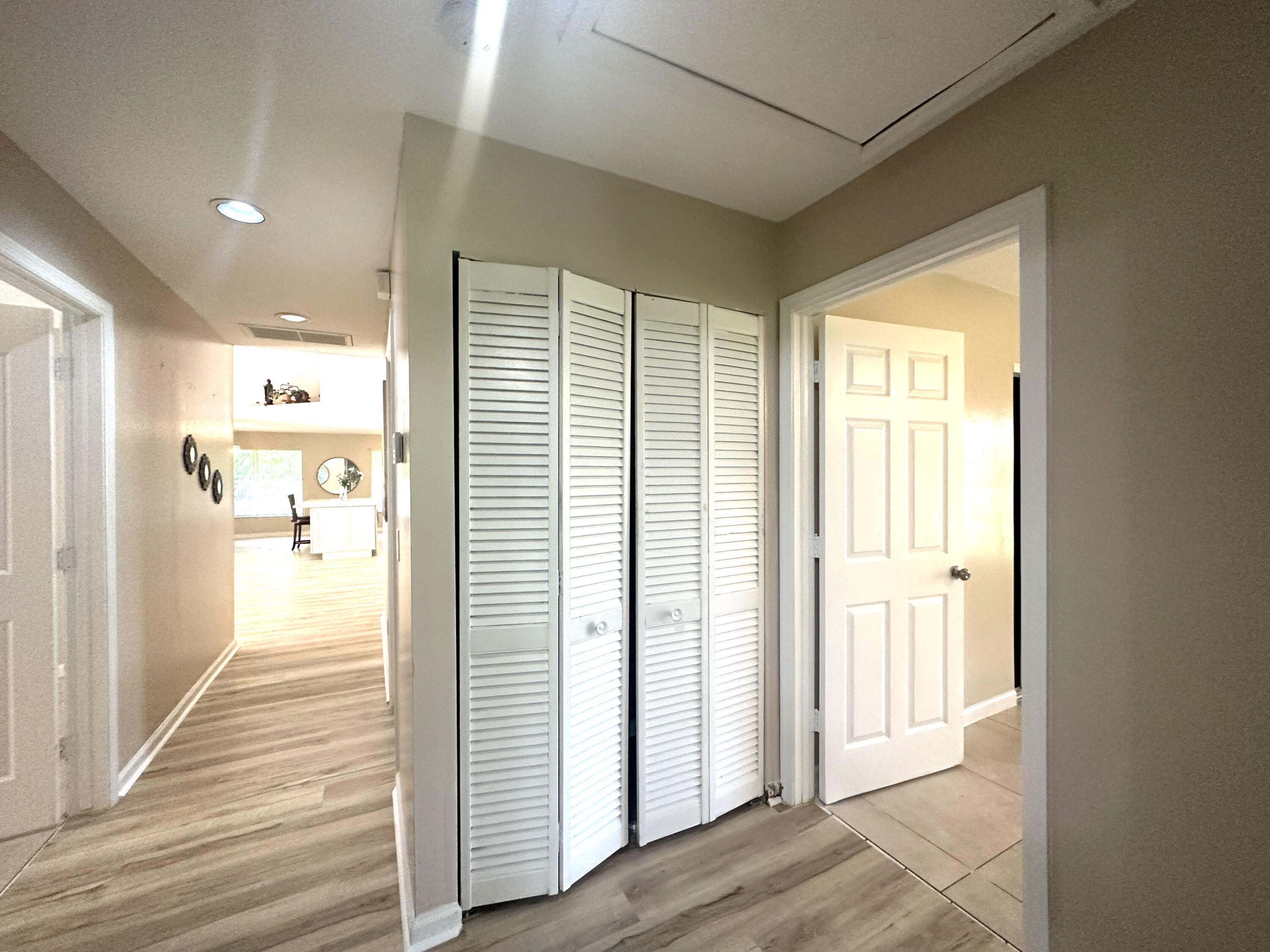13338 76th Road North West Palm Beach, FL 33412 - Photo 97 of 138 a view of a hallway with wooden floor and windows