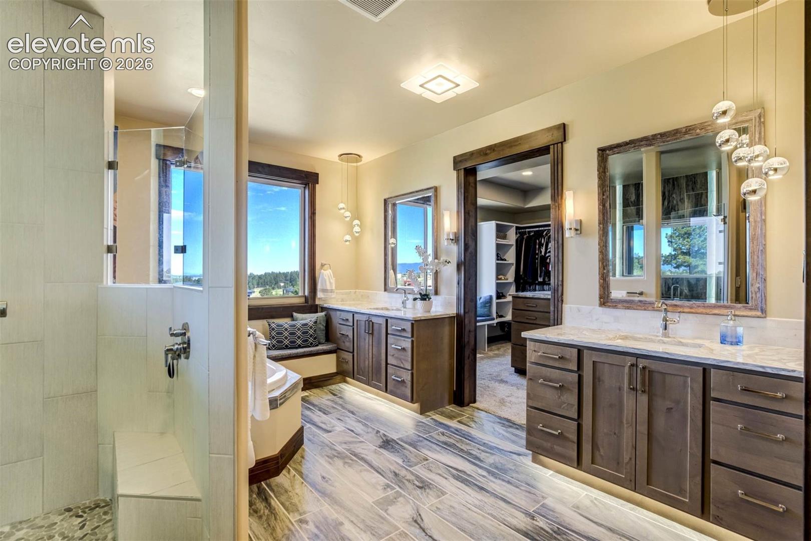 4695 Settlers Ranch Road Colorado Springs, CO 80908 - Photo 7 of 41 Master Bath features dual vanities, luxurious shower, soaking tub, separate water closet, and heated floors