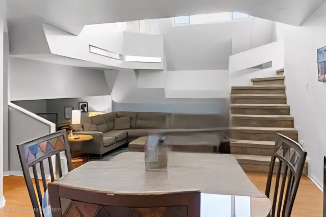 a kitchen with a table chairs and stove in it