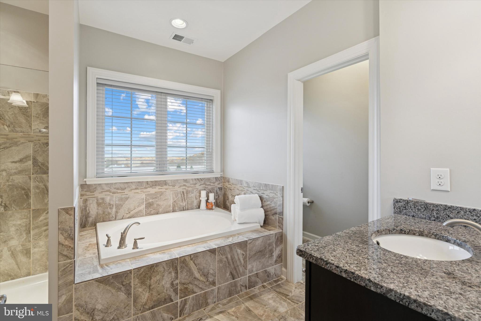 1392 Hickory Hill Road Chadds Ford, PA 19317 - Photo 20 of 35 a bathroom with a granite countertop tub sink and mirror