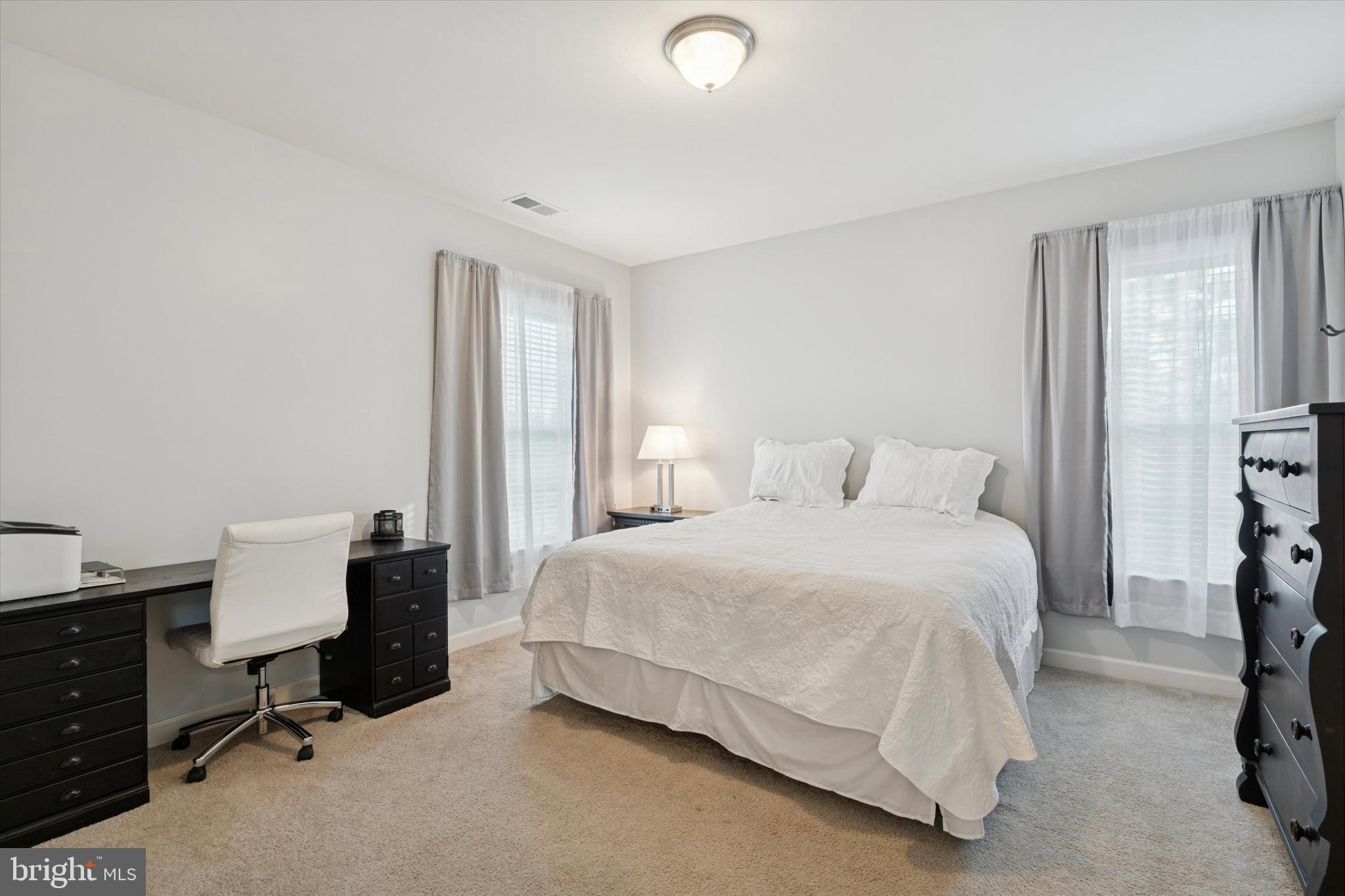 1392 Hickory Hill Road Chadds Ford, PA 19317 - Photo 24 of 35 a bedroom with a bed and large windows