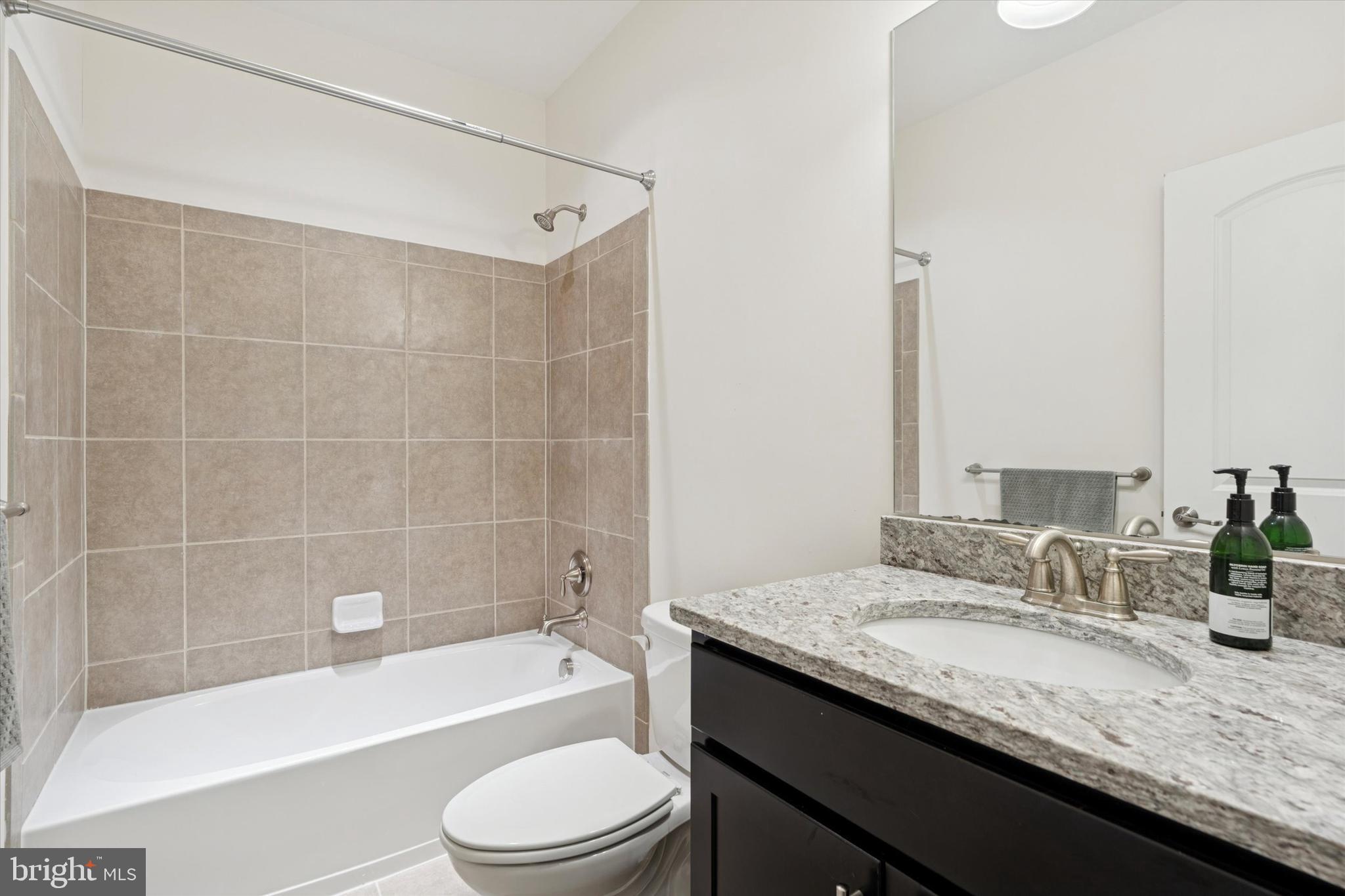 1392 Hickory Hill Road Chadds Ford, PA 19317 - Photo 27 of 35 a bathroom with a granite countertop bathtub shower sink vanity mirror and toilet