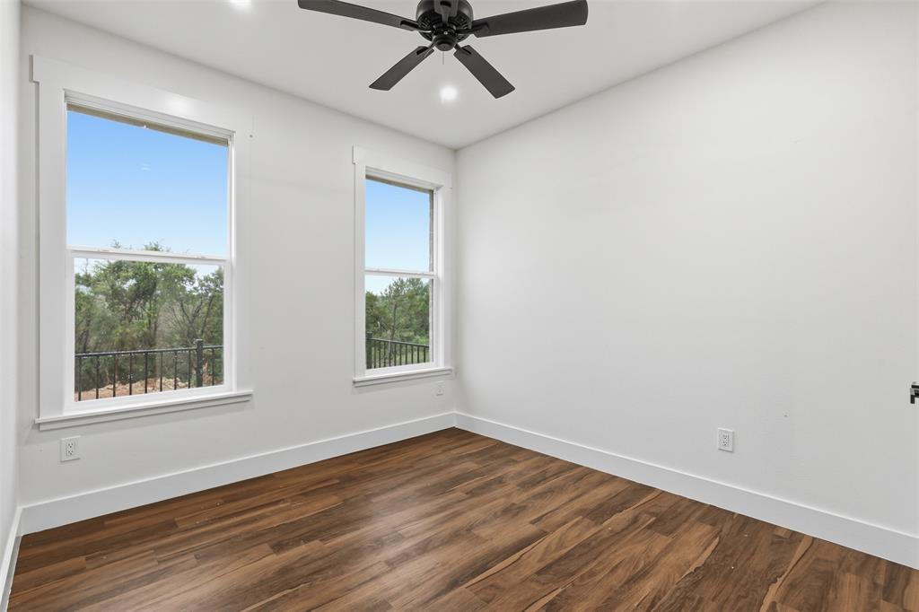 1413 Ridgeview Circle Granbury, TX 76048 - Photo 16 of 35 Room featuring wood-finish flooring, white baseboards, and bright white walls