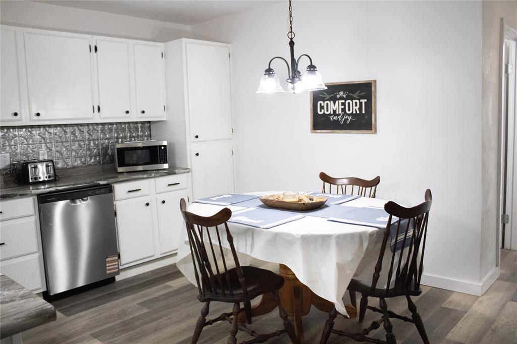 214 County Road 2147 Quitman, TX 75783 - Photo 11 of 38 a view of a dining room with furniture and wooden floor