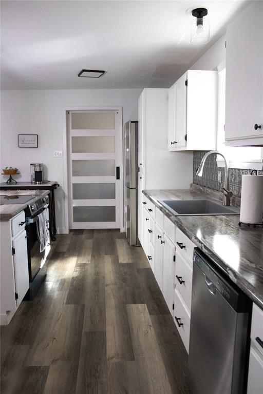214 County Road 2147 Quitman, TX 75783 - Photo 13 of 38 a kitchen with a sink stove and cabinets