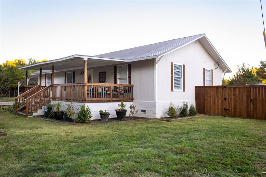 214 County Road 2147 Quitman, TX 75783 - Photo 2 of 38 a view of a house with a yard and sitting area