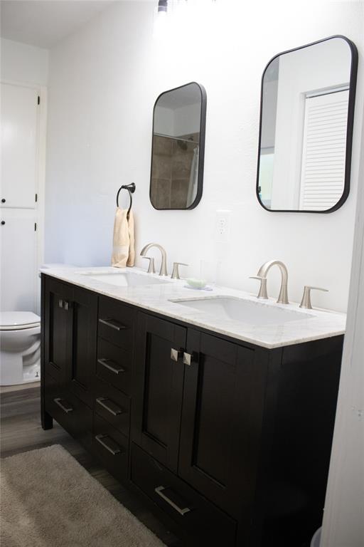 214 County Road 2147 Quitman, TX 75783 - Photo 28 of 38 a bathroom with a double vanity sink and a mirror