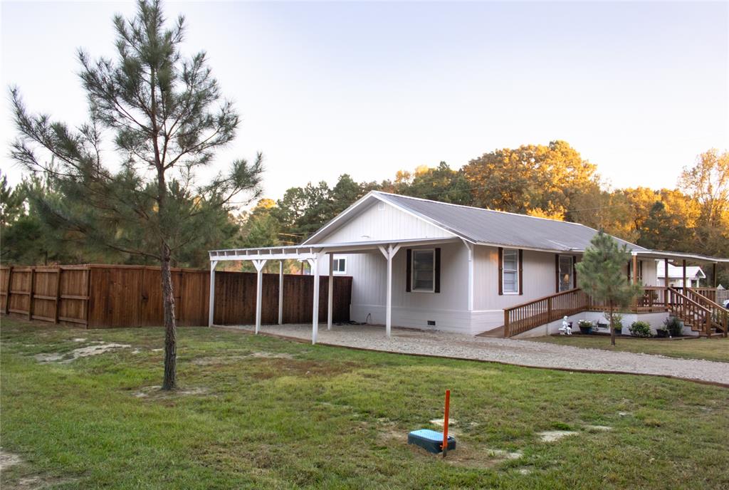 214 County Road 2147 Quitman, TX 75783 - Photo 3 of 38 a front view of a house with garden