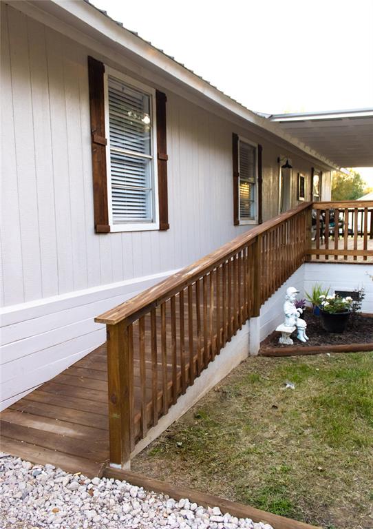 214 County Road 2147 Quitman, TX 75783 - Photo 4 of 38 a view of a balcony with two chairs