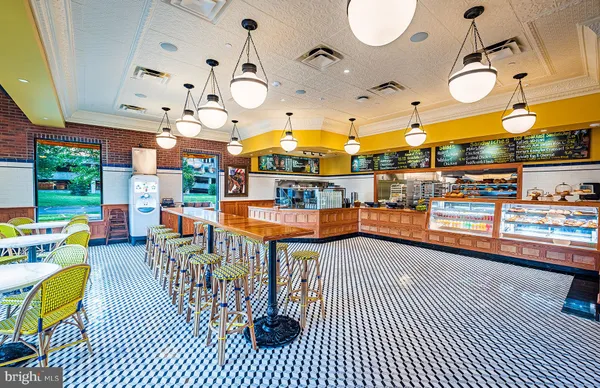 a living room with lots of furniture and a chandelier