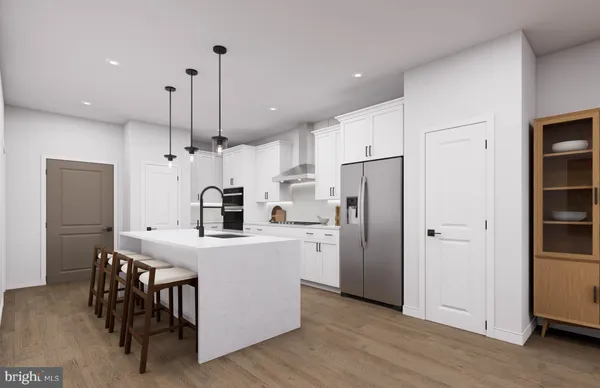 a kitchen with kitchen island a refrigerator a stove a sink and a dining table with wooden floor