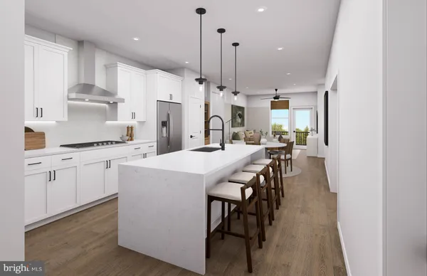 a kitchen with kitchen island a wooden floor and white appliances