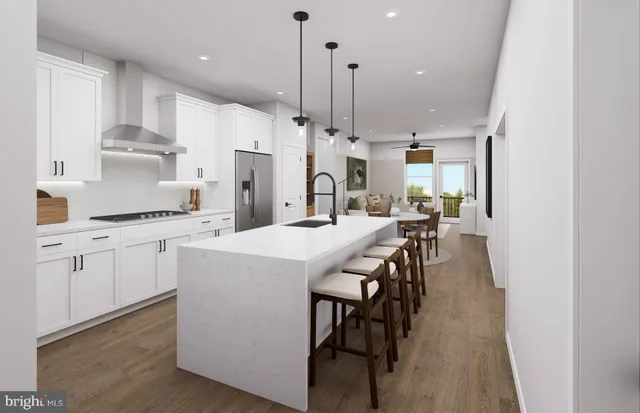a kitchen with kitchen island a wooden floor and white appliances