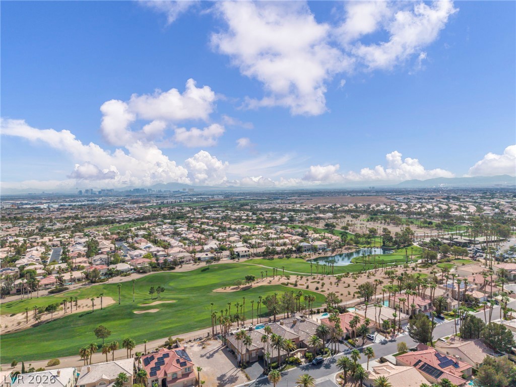 389 Fringe Ruff Drive Las Vegas, NV 89148 - Photo 47 of 53 Expansive neighborhood vistas unfold across a lush golf course green under bright desert skies.