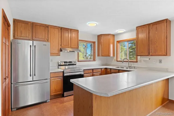 a kitchen with a sink stove and microwave