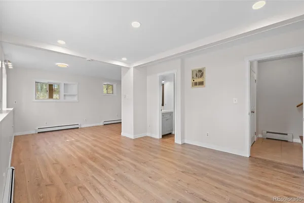 a view of an empty room with wooden floor
