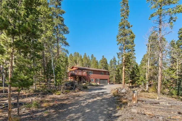 a view of a house with a yard and sitting area