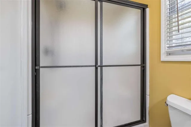 a bathroom with a shower and a toilet