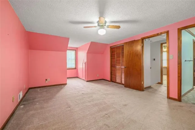 a view of a livingroom with a ceiling fan and window