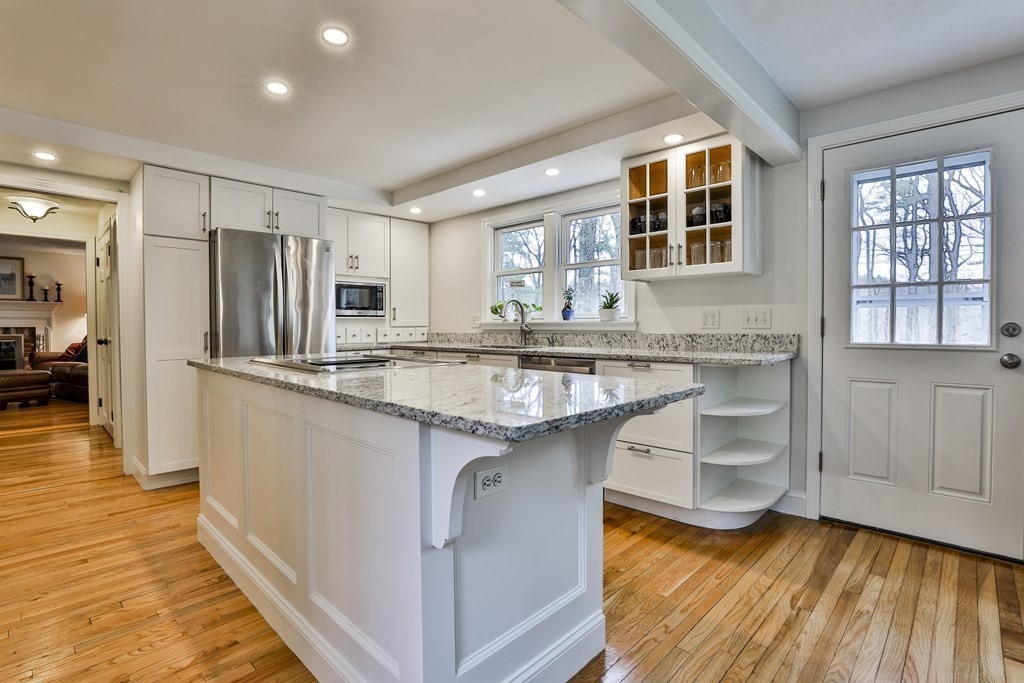 93 Teele Road Bolton, MA 01740 - Photo 15 of 40 a kitchen with center island wooden floor and stainless steel appliances