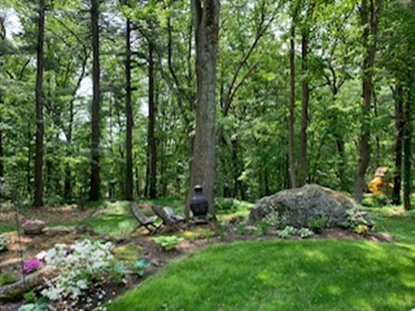 93 Teele Road Bolton, MA 01740 - Photo 2 of 40 a backyard of a house with lots of green space and chair