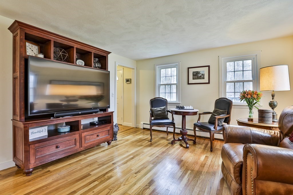 93 Teele Road Bolton, MA 01740 - Photo 28 of 40 a living room with furniture and a flat screen tv