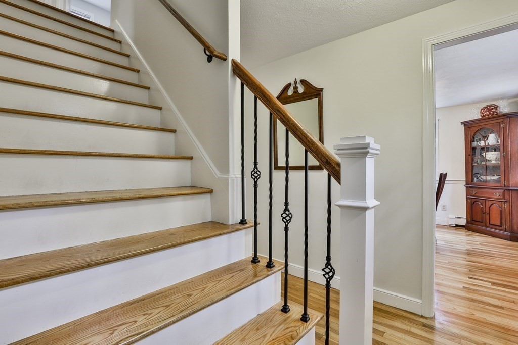 93 Teele Road Bolton, MA 01740 - Photo 29 of 40 a view of staircase with wooden floor and a rug