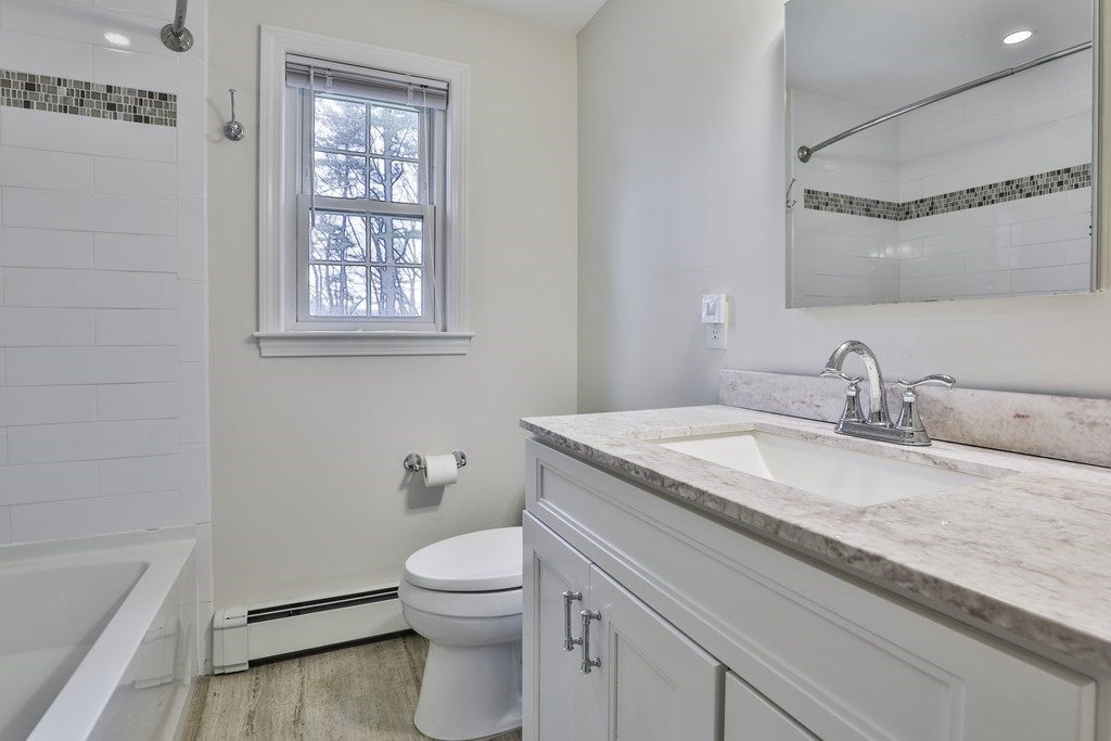 93 Teele Road Bolton, MA 01740 - Photo 34 of 40 a bathroom with a granite countertop sink a toilet and a bathtub