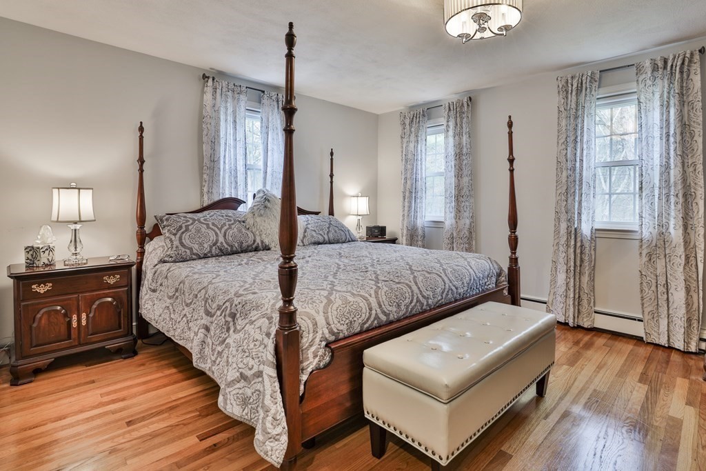 93 Teele Road Bolton, MA 01740 - Photo 35 of 40 a bedroom with a bed window and wooden floor