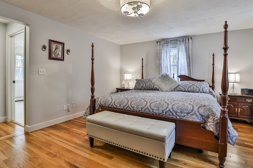 93 Teele Road Bolton, MA 01740 - Photo 36 of 40 a bedroom with a bed window and wooden floor