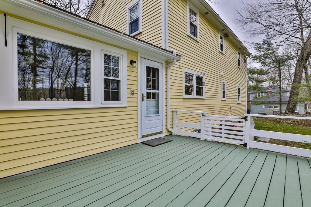 93 Teele Road Bolton, MA 01740 - Photo 9 of 40 a view of a wooden deck with a yard