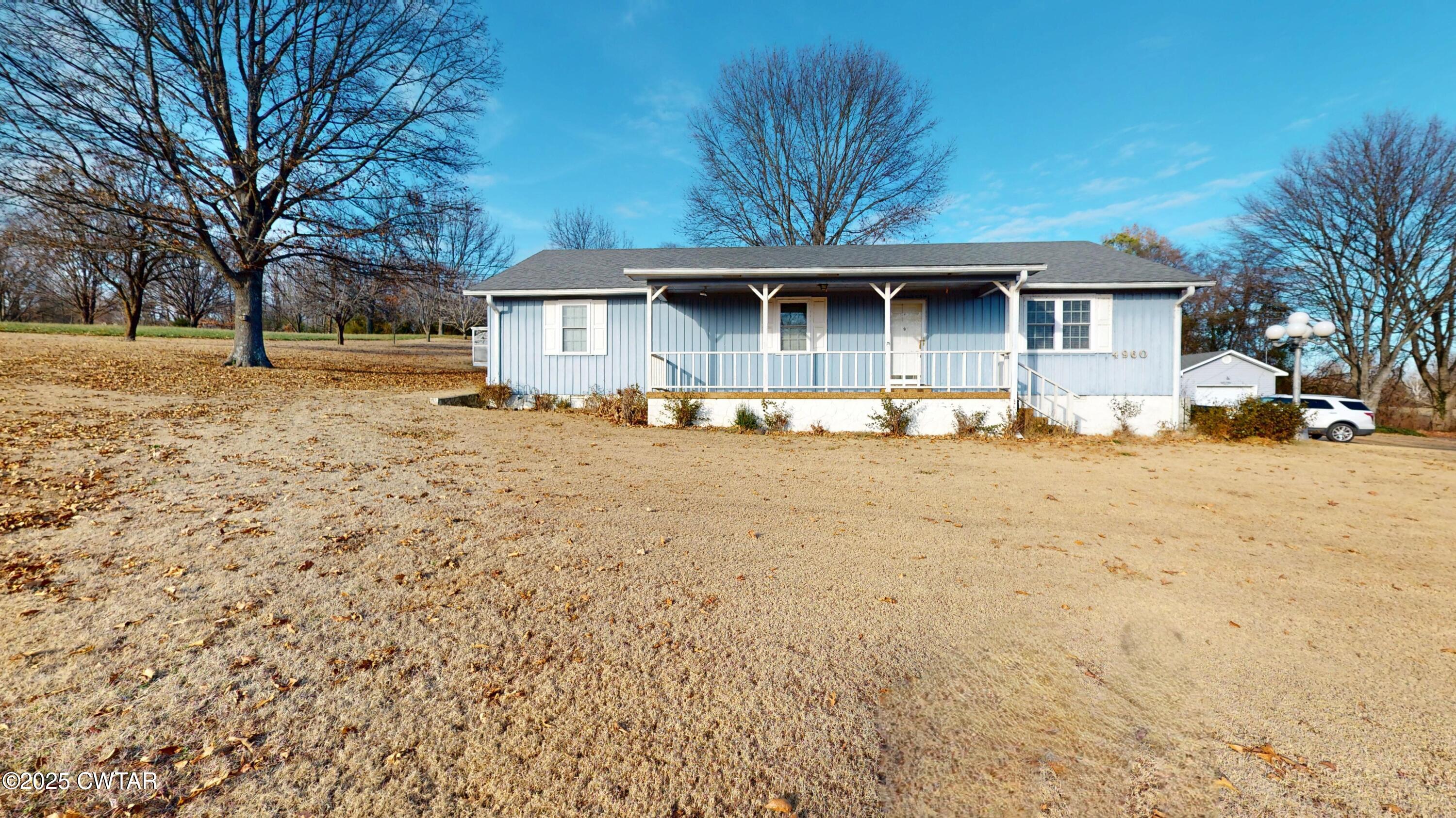 4960 Upper Finley Road Dyersburg, TN 38024 - Photo 1 of 39 a front view of a house with a yard covered with snow