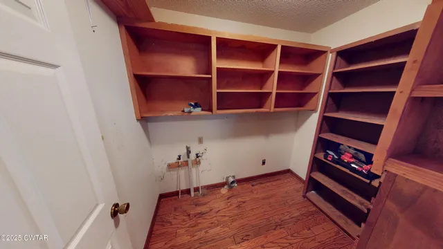 a view of room with wooden floor and closet