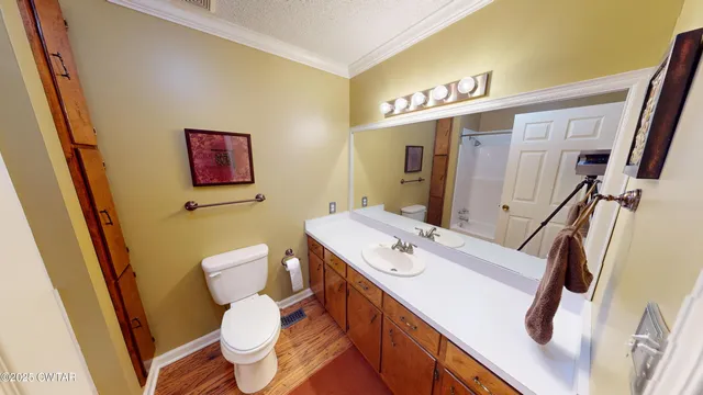 a bathroom with a sink a toilet a mirror and shower