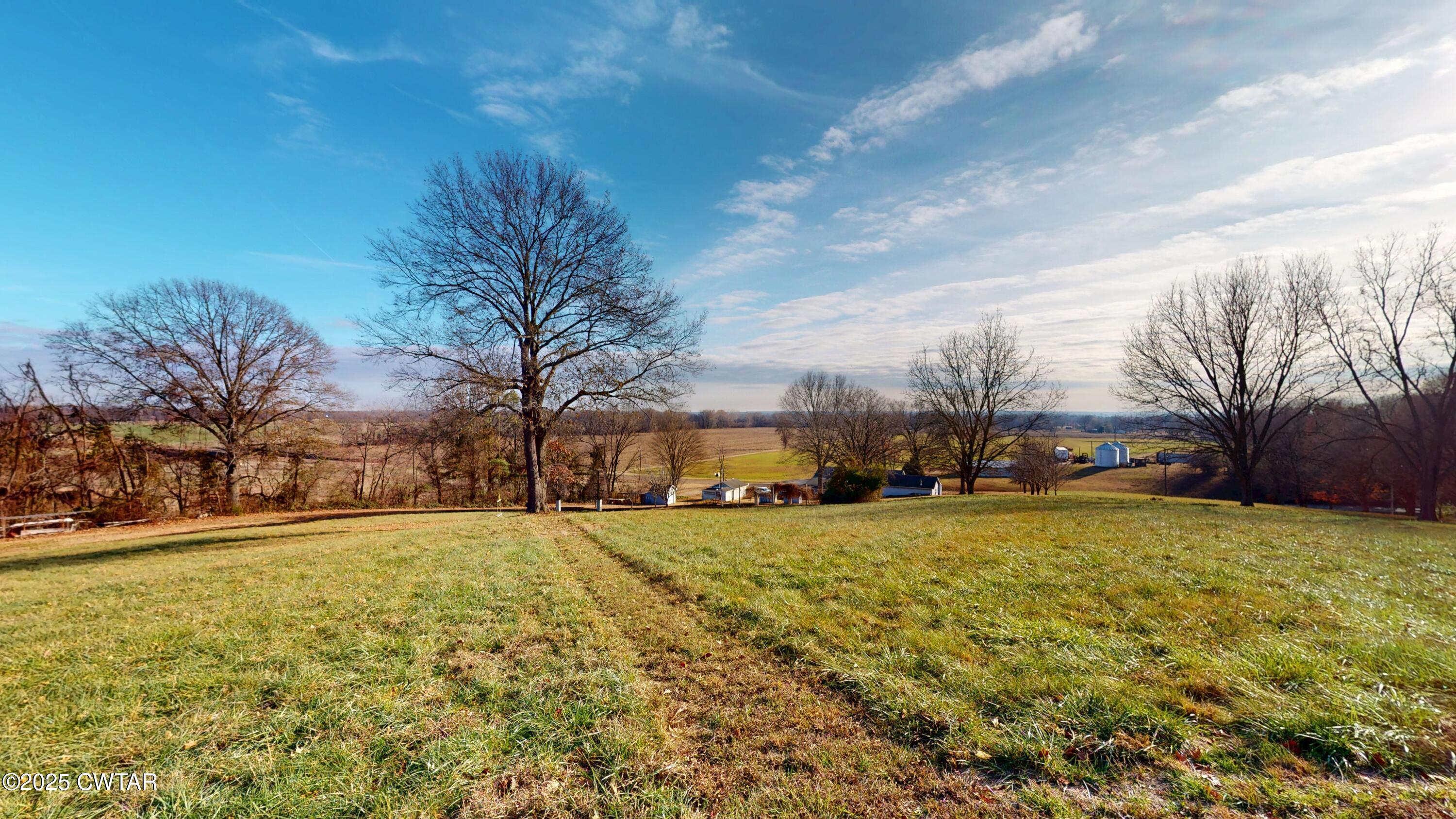 4960 Upper Finley Road Dyersburg, TN 38024 - Photo 26 of 39 a view of a large house with a large trees and yard