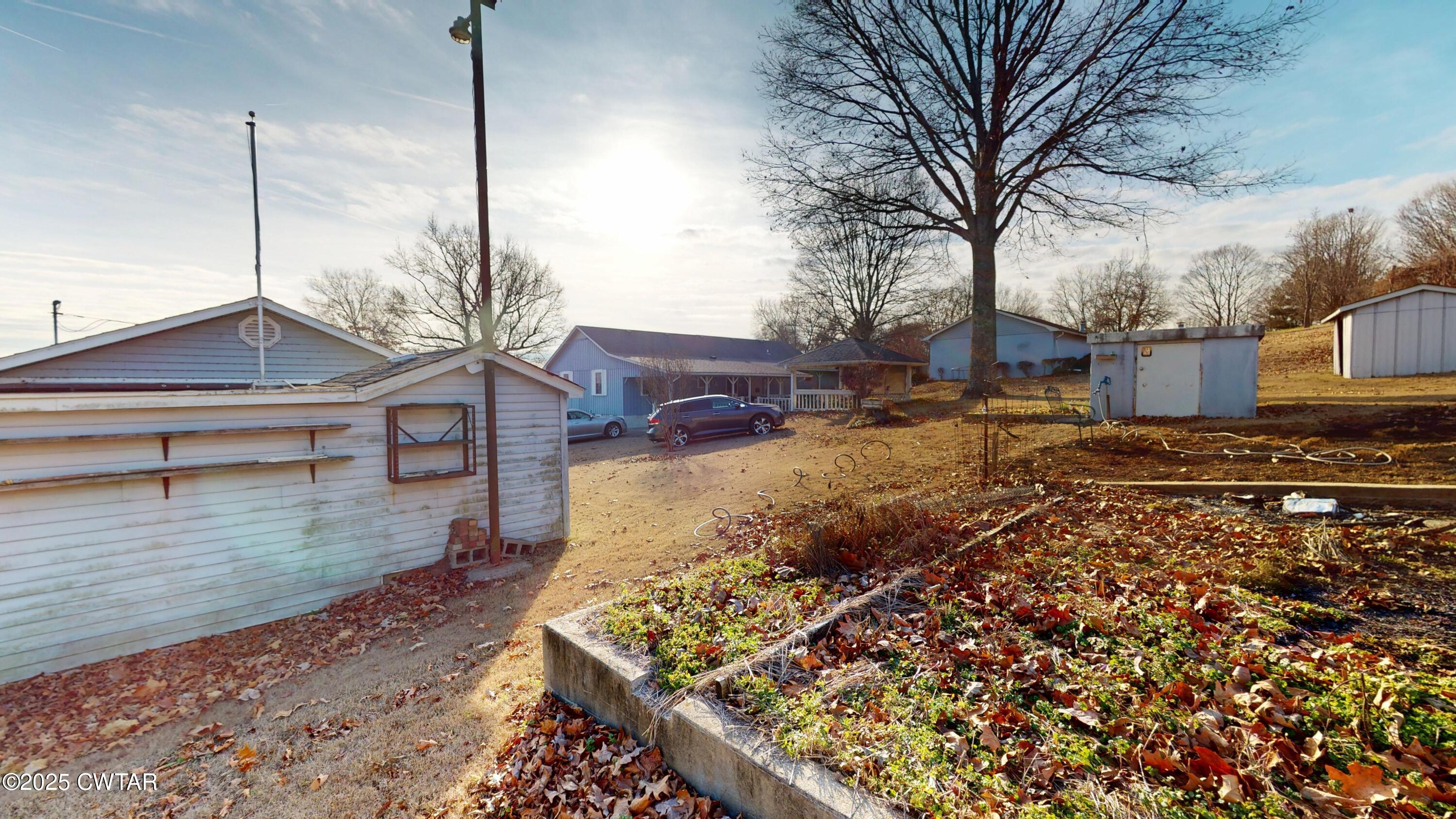 4960 Upper Finley Road Dyersburg, TN 38024 - Photo 29 of 39 a backyard of a house with lots of green space