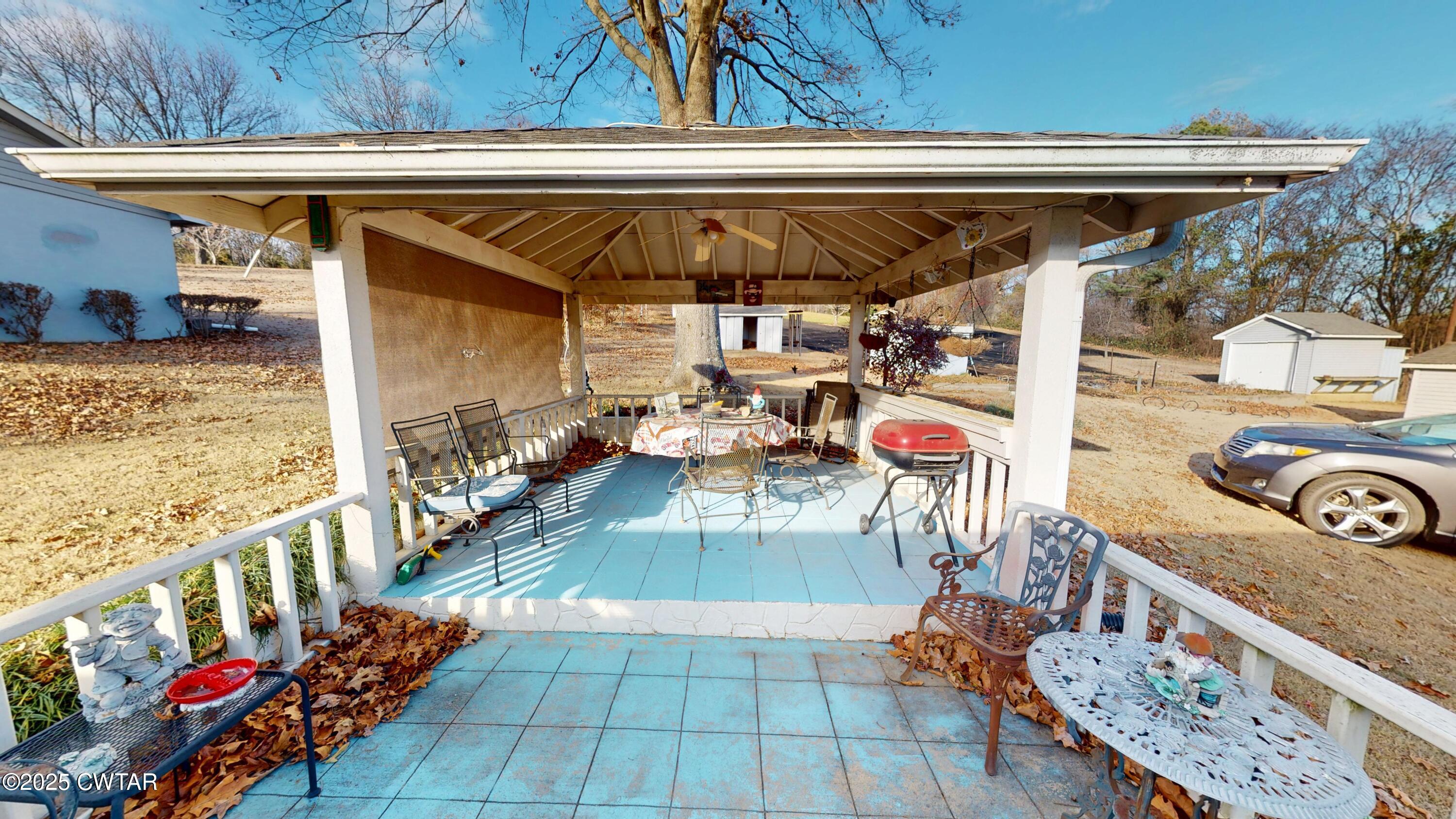 4960 Upper Finley Road Dyersburg, TN 38024 - Photo 32 of 39 a view of a patio with table and chairs potted plants