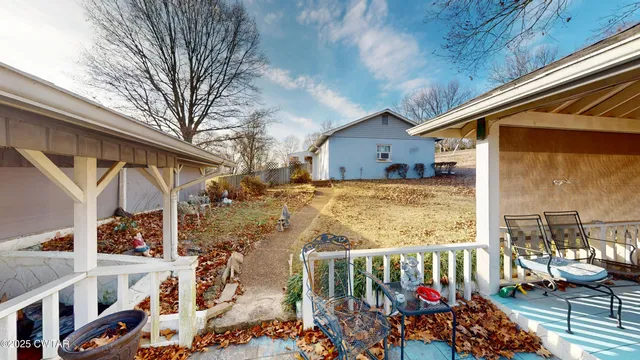 a view of a balcony with yard