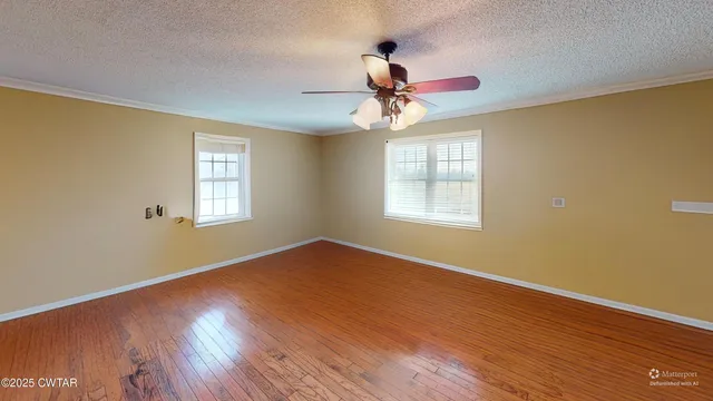 a view of a room with wooden floor closet and windows