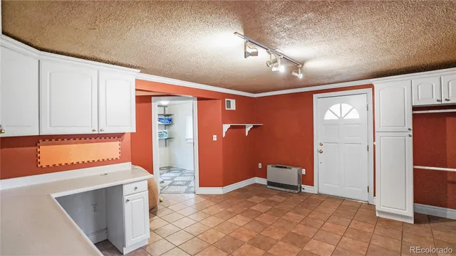 a view of a wooden chairs and iron fence