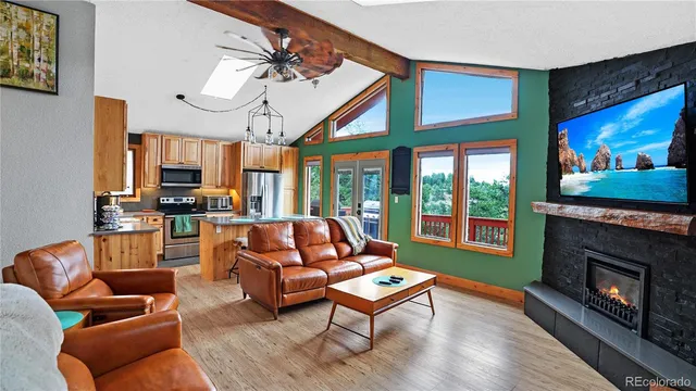 a living room with furniture fireplace and flat screen tv
