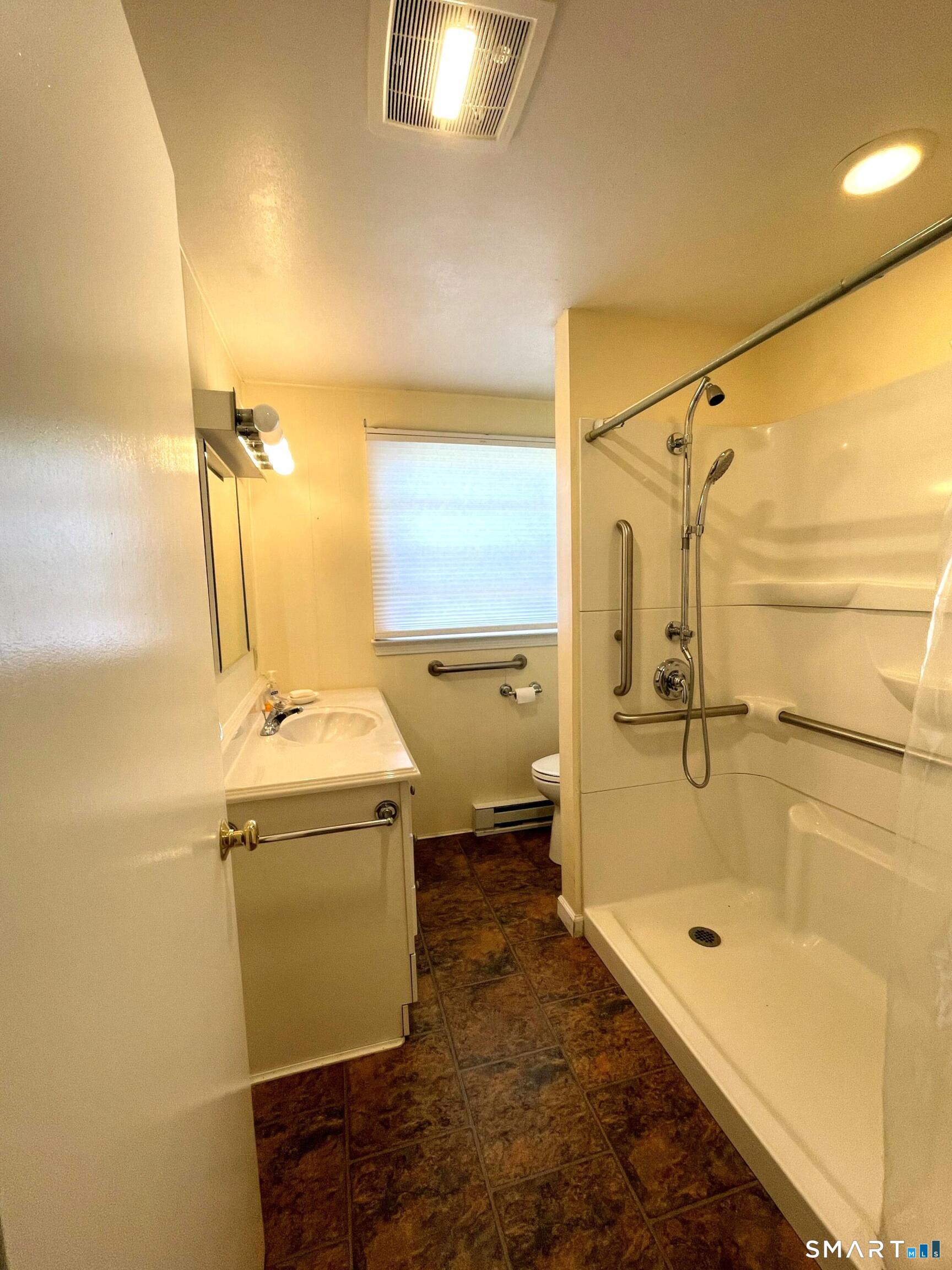 18 Old South Cove Road Old Saybrook, CT 06475 - Photo 38 of 40 a bathroom with a granite countertop sink mirror vanity and bathtub