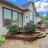 a view of a backyard with table and chairs potted plants and wooden fence