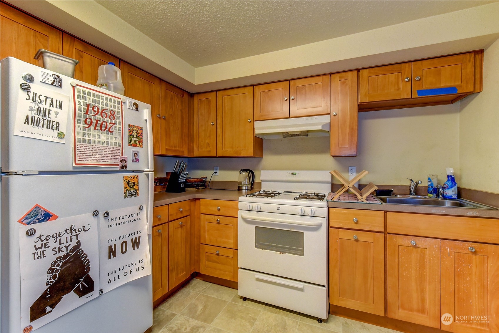 911 24th Avenue Seattle, WA 98122 - Photo 16 of 20 a kitchen with a stove a sink and cabinets