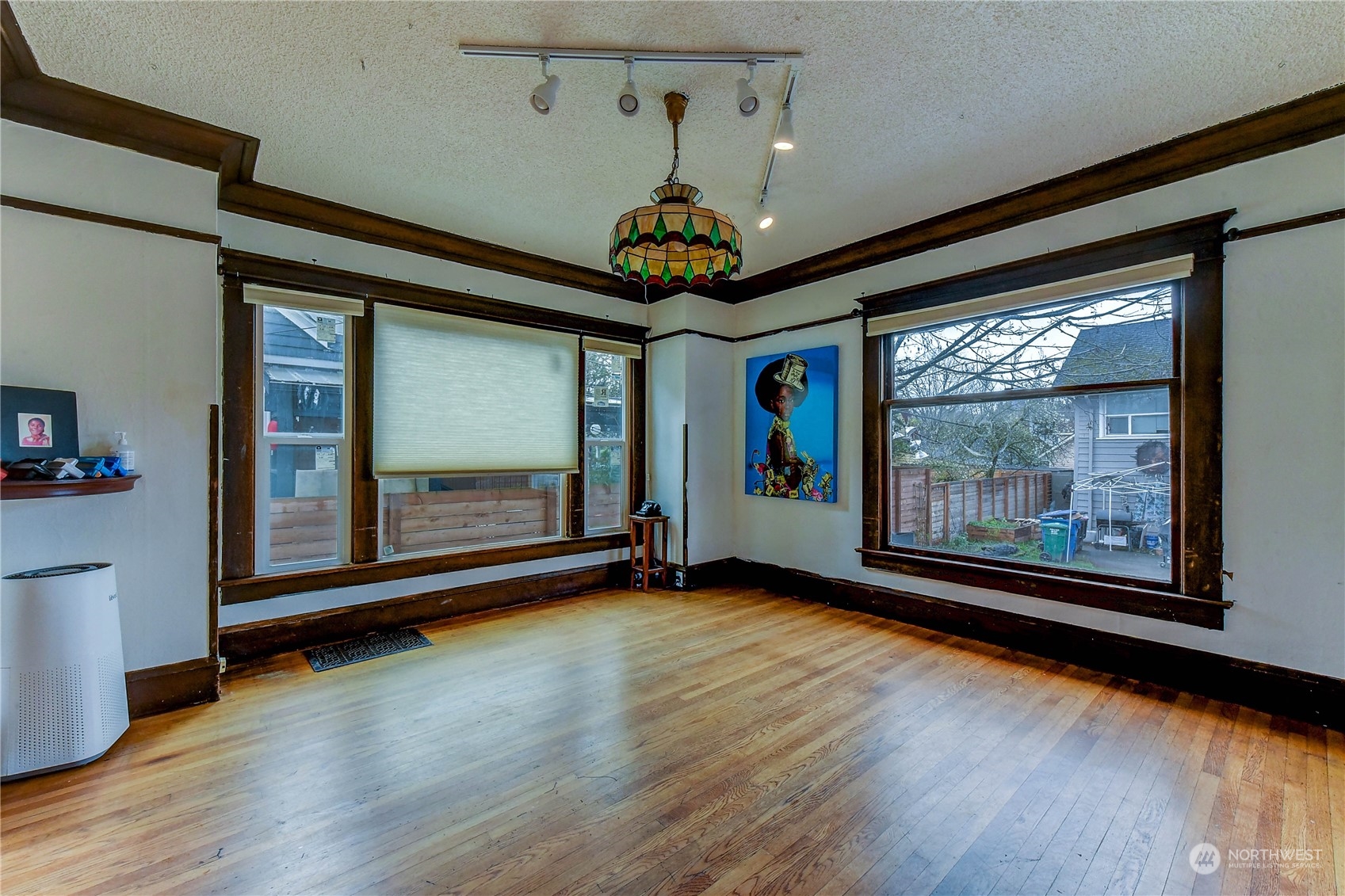 911 24th Avenue Seattle, WA 98122 - Photo 6 of 20 a view of an empty room with wooden floor and a window