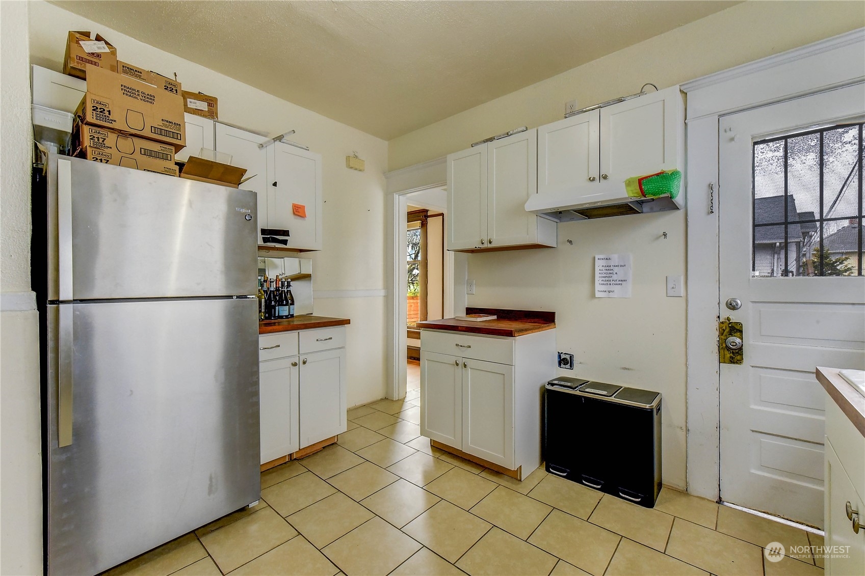 911 24th Avenue Seattle, WA 98122 - Photo 8 of 20 a kitchen with stainless steel appliances a refrigerator sink and cabinets