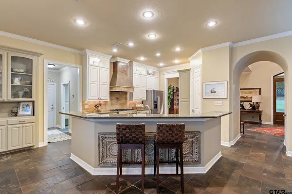 a large kitchen with a table and chairs